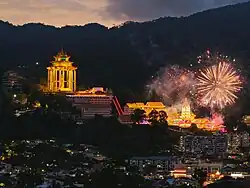 Temple at night illuminated with light from decorations
