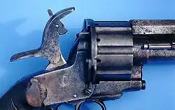 A close-up of the hammer on a LeMat Pinfire Revolver shows the pivoting striker that could be used to fire the pinfire cartridges in the revolving chambers or the secondary smoothbore barrel.