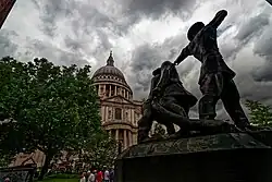 A northern perspective of Peter’s Hill from Carter Lane depicts a 1990 sculpture by John William Mills, titled “Blitz”. It is also the National Firefighter’s Memorial.
