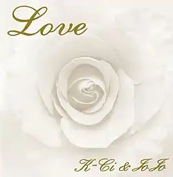 A faded-sepia-toned rose with "Love" written in gold script in the top left of the cover and "K-Ci & JoJo" in the bottom right.