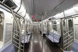 R179 car has numerous handholds and looped stanchions for high capacity services in New York City