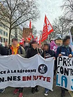 Protest against the pension reform in Lyon with a banner on which there is the MNL logo