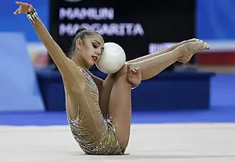 Mamun sits with the ball held between her head and raised knees