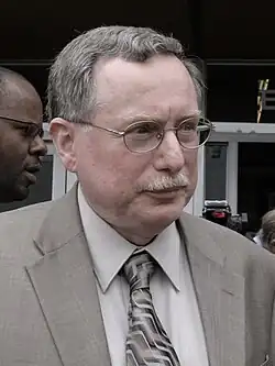 Headshot of Klein in a suit outdoors