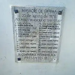 "plaque mounted to the wall by four corners, black lettering carved in marble or similar polished stone. Top line says 'MASACRE DE FATIMA', second line reads '20 de agosto de 1976', third line is the inscription 'LOS PUEBLOS SIN MEMORIA NO TIENEN FUTURO'. Below that making up the bilk of the face are 2 columns of numbered spots for names of victims, though 7 spots are blank (possibly ubidentified?). At the bottom is the text '30 COMPAÑEROS ASESINADOS ACA PRESENTES!!!'. Listed names may be found in section below