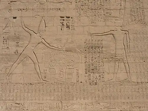 fight scene, a man strikes another man on the ground with a club