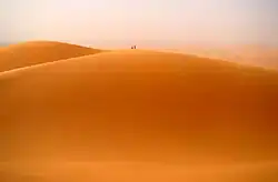 Two people atop one of the main dunes
