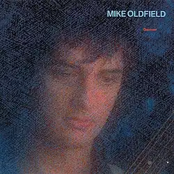 A blue mottled image of Oldfield's face and a portion of a guitar neck. The words Mike Oldfield Discovery are to the top right of the image.
