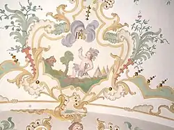 18th-century stucco in the Jesuit church, Mindelheim. Now tepees and a bison appear to the sides, though the old South American feather costume remains.