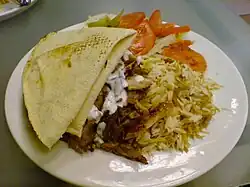 Mixed shawarma with rice and tomatoes