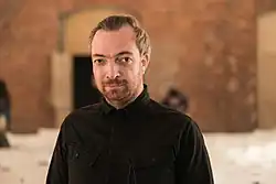 Liam Young wearing a black shirt, looking directly at camera