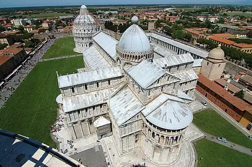Pisa Cathedral from the "Leaning Tower" shows the Latin Cross form, with projecting apse, foreground, and free-standing baptistry at the west.