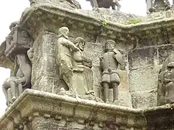 Jesus is sat on a "pretend" throne and mocked by two guards.