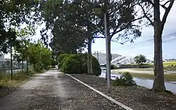 Walking trail near the Currents Bridge and the city, at the mouth of the Rons River