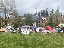 The pro-Palestine "Popular University for Gaza" encampment at the University of Oregon on the Memorial Quad in front of the Lillis Business Complex in April 2024. A sign in front reads "Divest from Death."