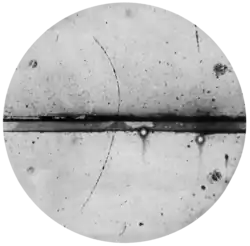 Curved arc shows a cloud chamber trajectory of a positron.