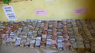 Sale of products in a Dajla pharmacy with posters in Spanish.