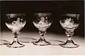 Three out of 10 goblets engraved by Alison Geissler and presented to Her Majesty Queen Elizabeth by the High Constables and the Guard of Honour of Holyrood House for the Coronation in 1953. The wineglasses are part of the Royal Collection. © Studio Swain, Glasgow.