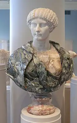 Museum bust with green verd antique drapery and an ancient Roman white Parian marble head of Agrippina Minor