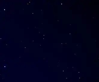 An image of the carbon star R Leporis as seen in binoculars. R Leporis is the red star right of centre. The bright star in the lower left corner is Mu Leporis.