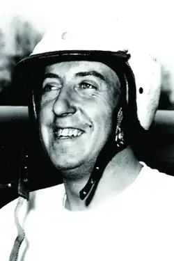 caucasian male looking to the left of the camera and wearing a racing helmet