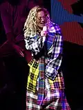 Rita Ora performing in Glasgow in 2018, wearing a tartan trench coat made of at least five different setts
