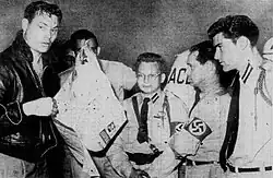 Rockwell standing to the left in front of four members of the ANP, all wearing Nazi outfits