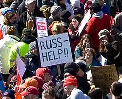 Sign in a crowd of protesters reading "Russ: help!!!"