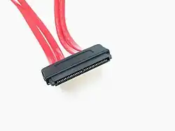 Four red cables lead into a wide black electrical connector