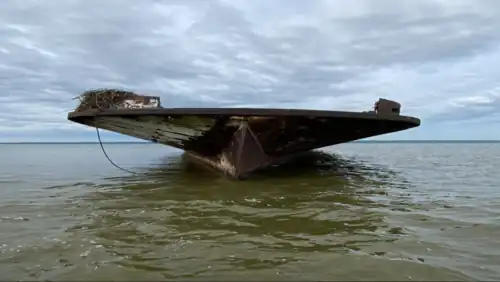 Bow view of a shipwreck with a bird's nest on it
