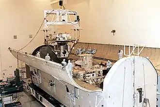 The Wake Shield Facility-3 (WSF-3) is lowered into the payload canister for STS-80 in the MPPF