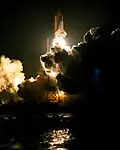 The space shuttle Endeavour launches on STS-89, lighting up the night time sky on its way to Mir.