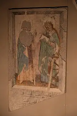 Painting of a man and a woman, face to face, dressed in blue dresses.