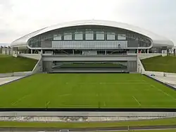 Retractable grass field shown outside the stadium