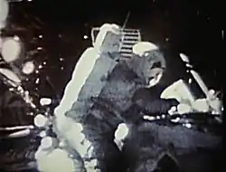 Image taken on the Moon showing an astronaut canceling an envelope (due to the poor quality, the envelope cannot be seen)