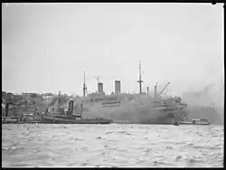 Ship surrounded by tug boats, Sydney, 1942