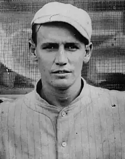 A man in a light baseball uniform