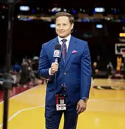 Josh Moser, wearing a Miami Heat press credential and reporting from a basketball arena and holding a microphone with the WSVN mic flag