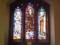 Stained glass west window depicting Mother Teresa, Edith Stein and Thérèse of Lisieux