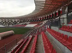 The stands of the stadium are tinted in red and white, displaying the colors of the club.