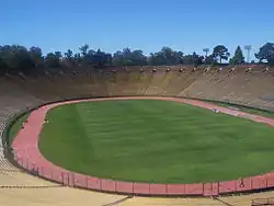A view of Stanford Stadium from the stands, showing the pitch encircled by a running track
