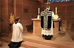 A Latin Catholic priest standing at the Epistle side during the offering of a Tridentine Mass