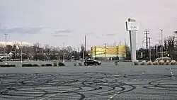Parking lot nearby the mall's sign.