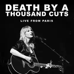 A black-and-white photograph of Swift playing the guitar. The white text "Death by a Thousand Cuts Live from Paris" is written above her.
