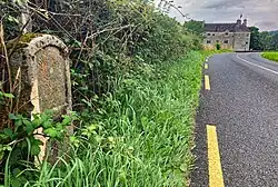 The Milestone on the road by Parke's Castle, indicating 7 miles to Sligo and 5 miles to Dromahair.
