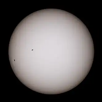 White glowing ball with black sunspots