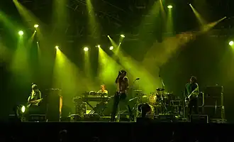 The Tears performing at Roskilde Festival in Denmark in 2005 (L–R: Nathan Fisher, Will Foster, Brett Anderson, Makoto Sakamoto, Bernard Butler).