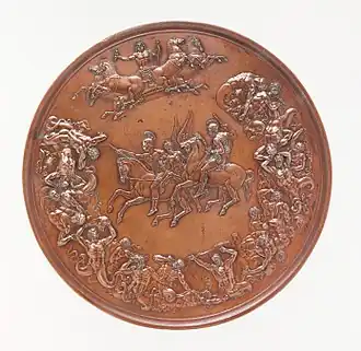 A bronze medal, with allegorical figures surrounding two equestrian figures in the centre