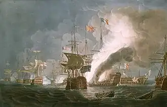 Coloured print of a naval battle between sailing ships. A single ship seen bow on in the centre, a cluster of ships in the left background, and a large ship on fire in the centre background. Two ships to the right, one without masts seen side on, and one seen stern on, are visible, with a column of smoke rising from the burning ship to the top of the picture.