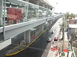 An metro station above an avenue.